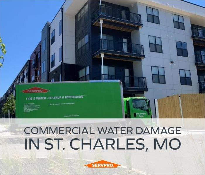 SERVPRO vehicle in front of large commercial loss. Text: Commercial Water Damage in St. Charles, MO 