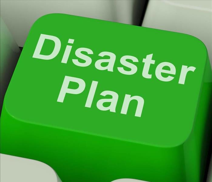 Green button of the keyboard of a computer with the word "Disaster Plan"