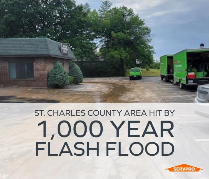 SERVPRO vehicles onsite of recent flooding with text: St. Charles County Hit By 1,000 Year Flash Flood