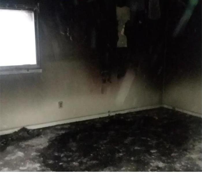 Burned room, walls covered with soot.
